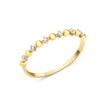 yellow gold ring with alternating beads and stones on white background