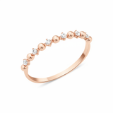 rose gold ring with alternating beads and stones on white background