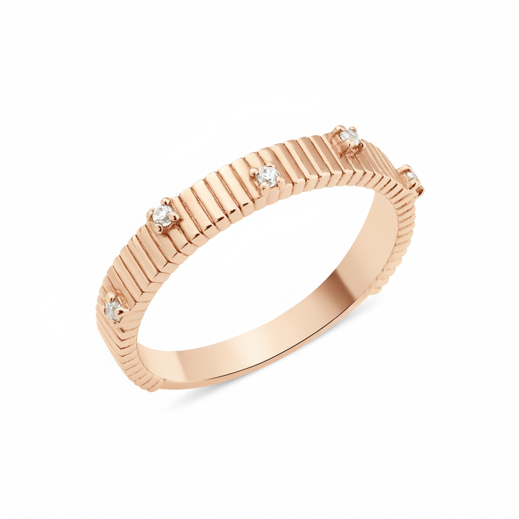 rose gold ribbed ring set with clear stones on white background