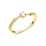 yellow gold ring with a channel of stones and a crowned center stone on white background