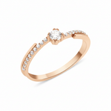 rose gold ring with a channel of stones and a crowned center stone on white background