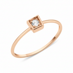 rose gold ring with a stone set in a square frame on white background