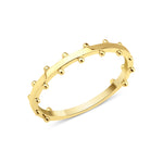 yellow gold ring with raised beaded texture on white background