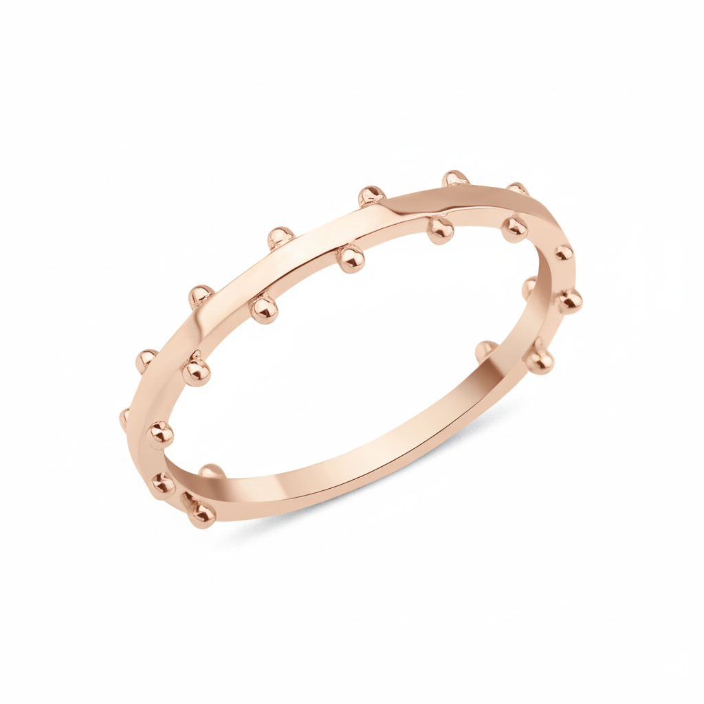 rose gold ring with raised beaded texture on white background