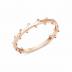 rose gold ring with raised beaded texture on white background