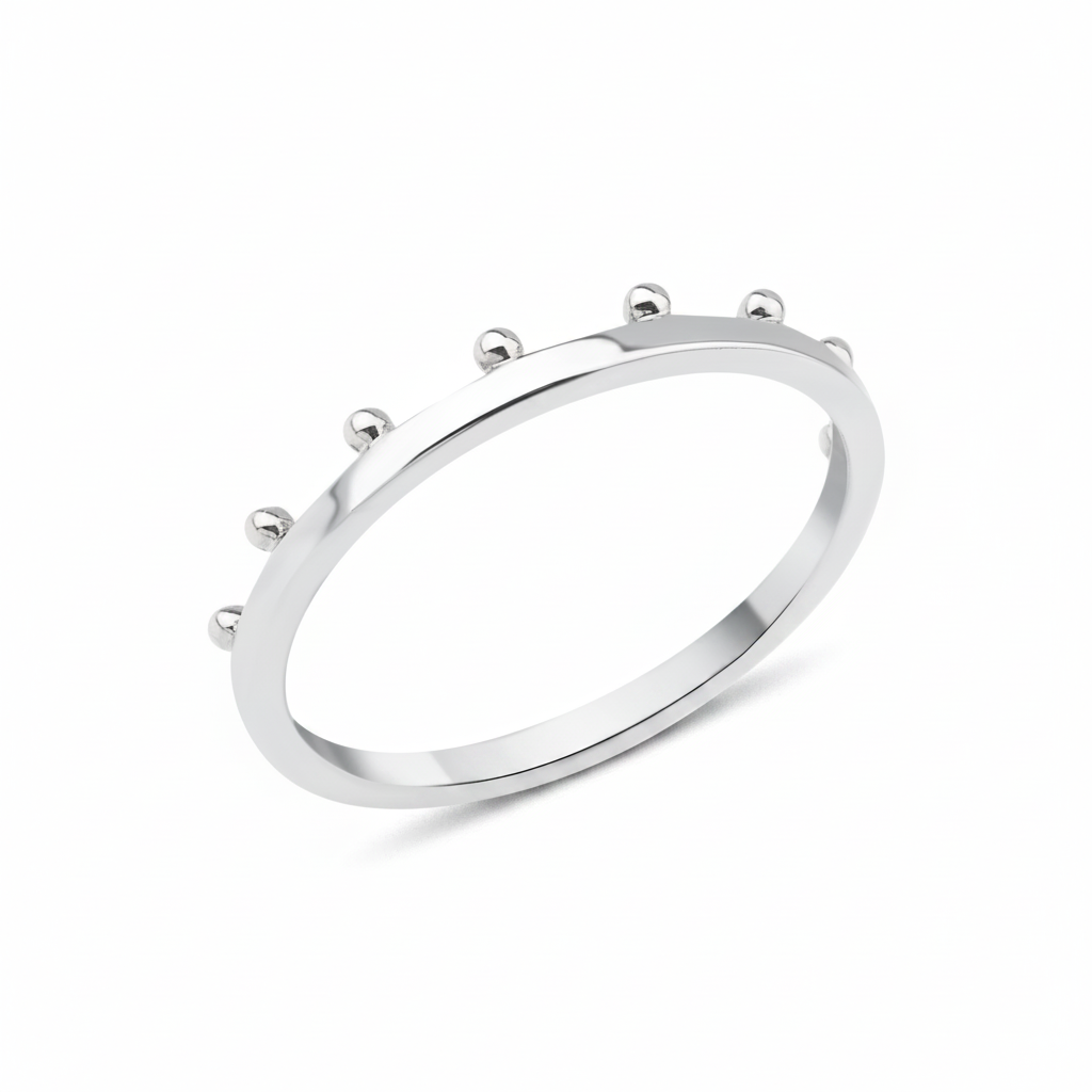 white gold ring with raised golden spheres along the edge on white background