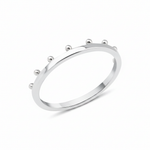 white gold ring with raised golden spheres along the edge on white background