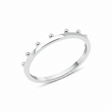 white gold ring with raised golden spheres along the edge on white background