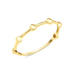 yellow gold ring punctuated with polished spheres on white background