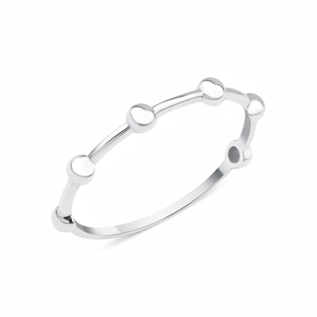 white gold ring punctuated with polished spheres on white background
