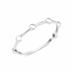 white gold ring punctuated with polished spheres on white background