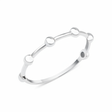 white gold ring punctuated with polished spheres on white background