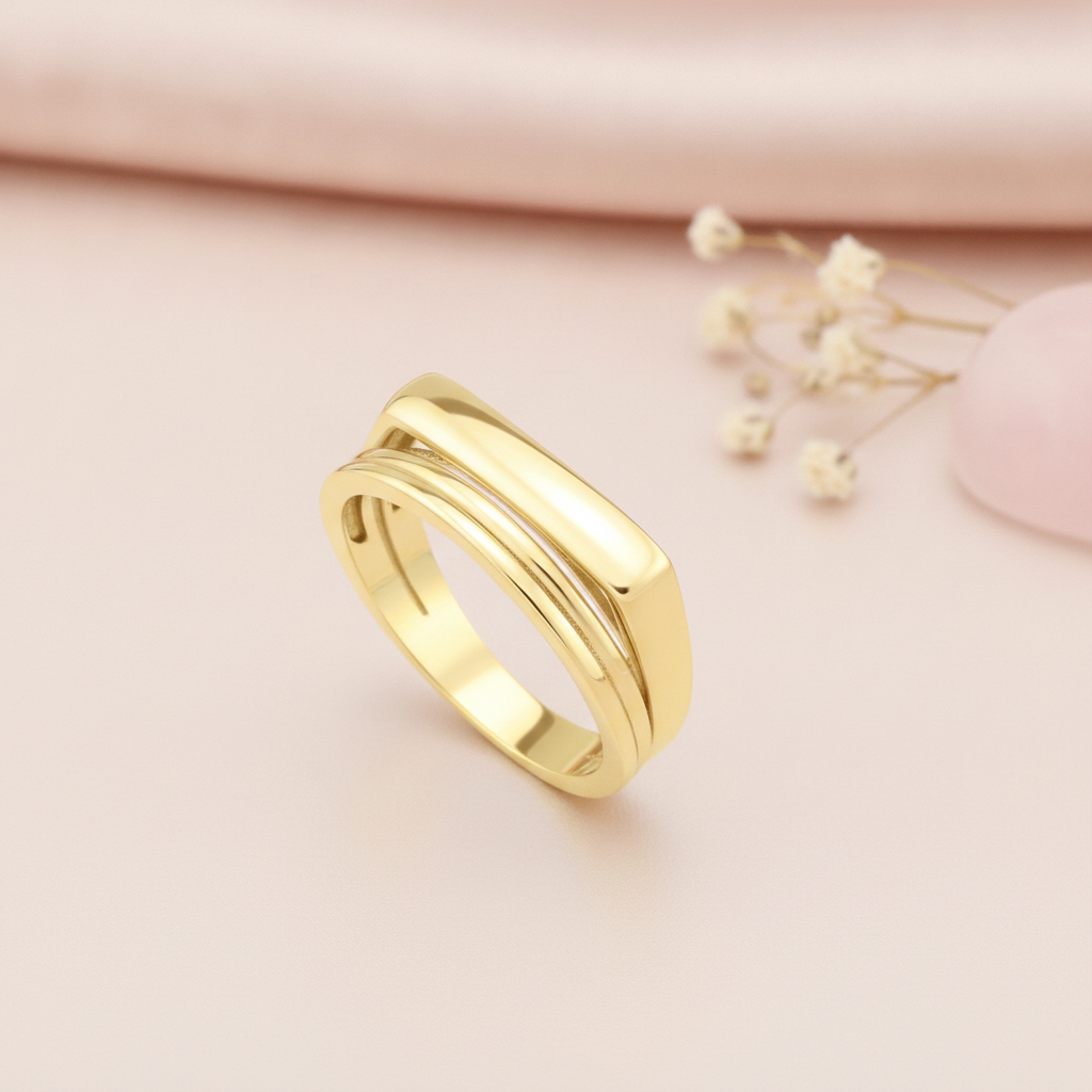 gold ring with a flat bar floating over a curved band, styled with a eucalyptus leaf and a pink stone on a cream background
