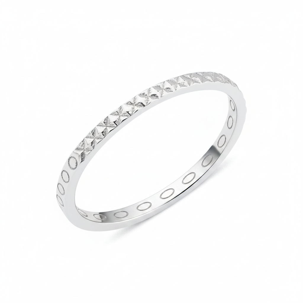 white gold ring with carved circle and cross texture on white background