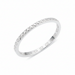 white gold ring with carved circle and cross texture on white background