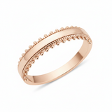 rose gold ring with a beaded ribbon texture on white background