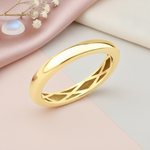 gold band ring with a carved lattice interior, styled with dried baby's breath and a moonstone on a pink and cream background