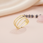 gold multi-band Linea ring with white inlay on a blush pink background with draped satin fabric and lavender sprigs