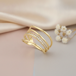 gold multi-band Linea ring with a row of White CZ stones on a blush and gray background with satin fabric and baby's breath
