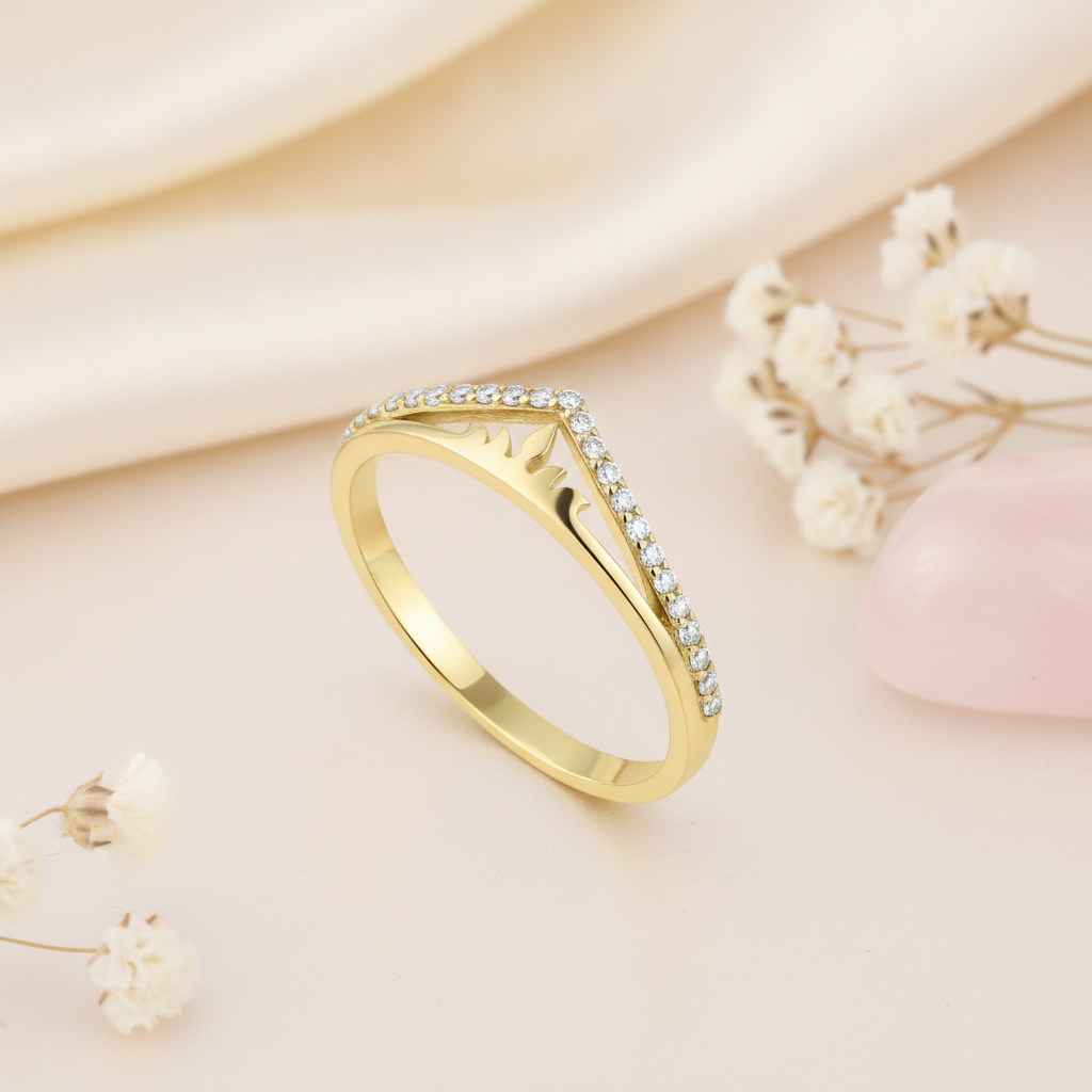 gold sunburst chevron ring with White CZ stones on a cream background with draped satin fabric and dried baby's breath