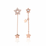 rose gold Astra asymmetrical star drop earrings on a white background