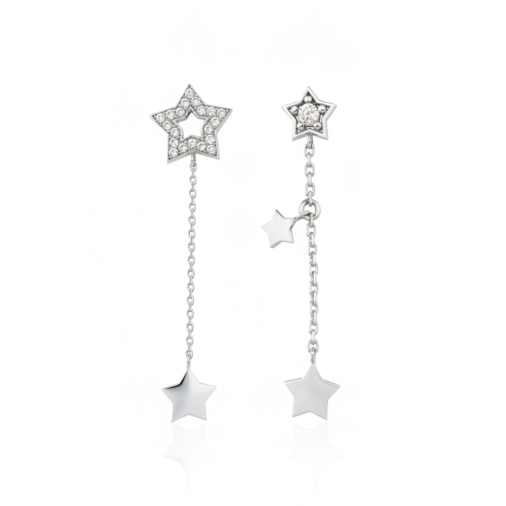 white gold Astra asymmetrical star drop earrings on a white background