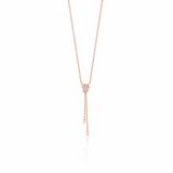 star drop necklace in rose gold on a white background
