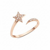 open star ring with a trailing arc in rose gold on a white background
