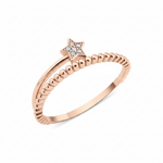 textured star band ring in rose gold on a white background