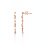 linear drop earrings in rose gold on a white background