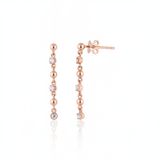 linear drop earrings in rose gold on a white background