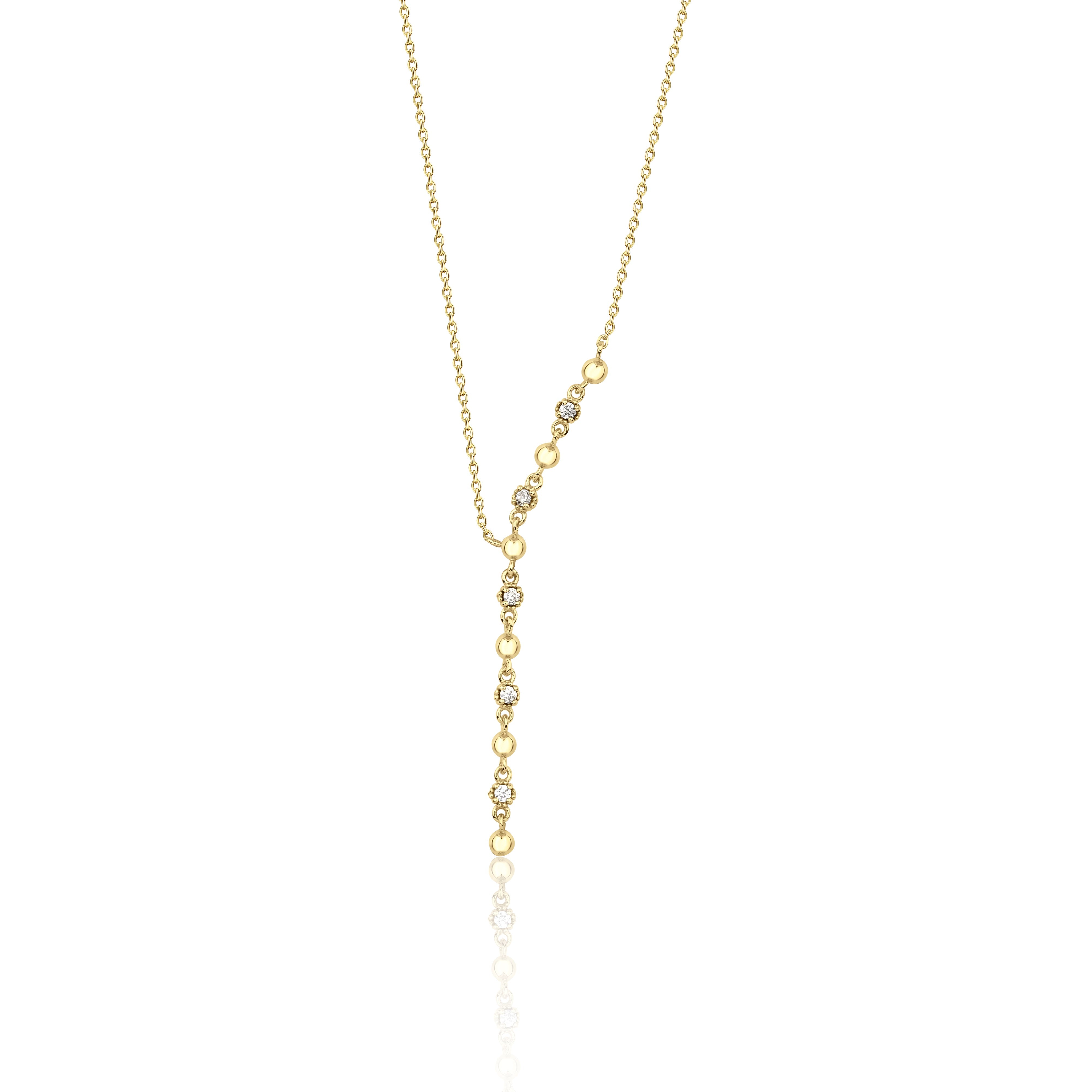 lariat necklace in yellow gold on a white background