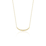 beaded arc necklace in yellow gold on a white background