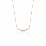 beaded arc necklace in rose gold on a white background