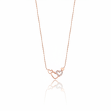 linked hearts necklace in rose gold on a white background