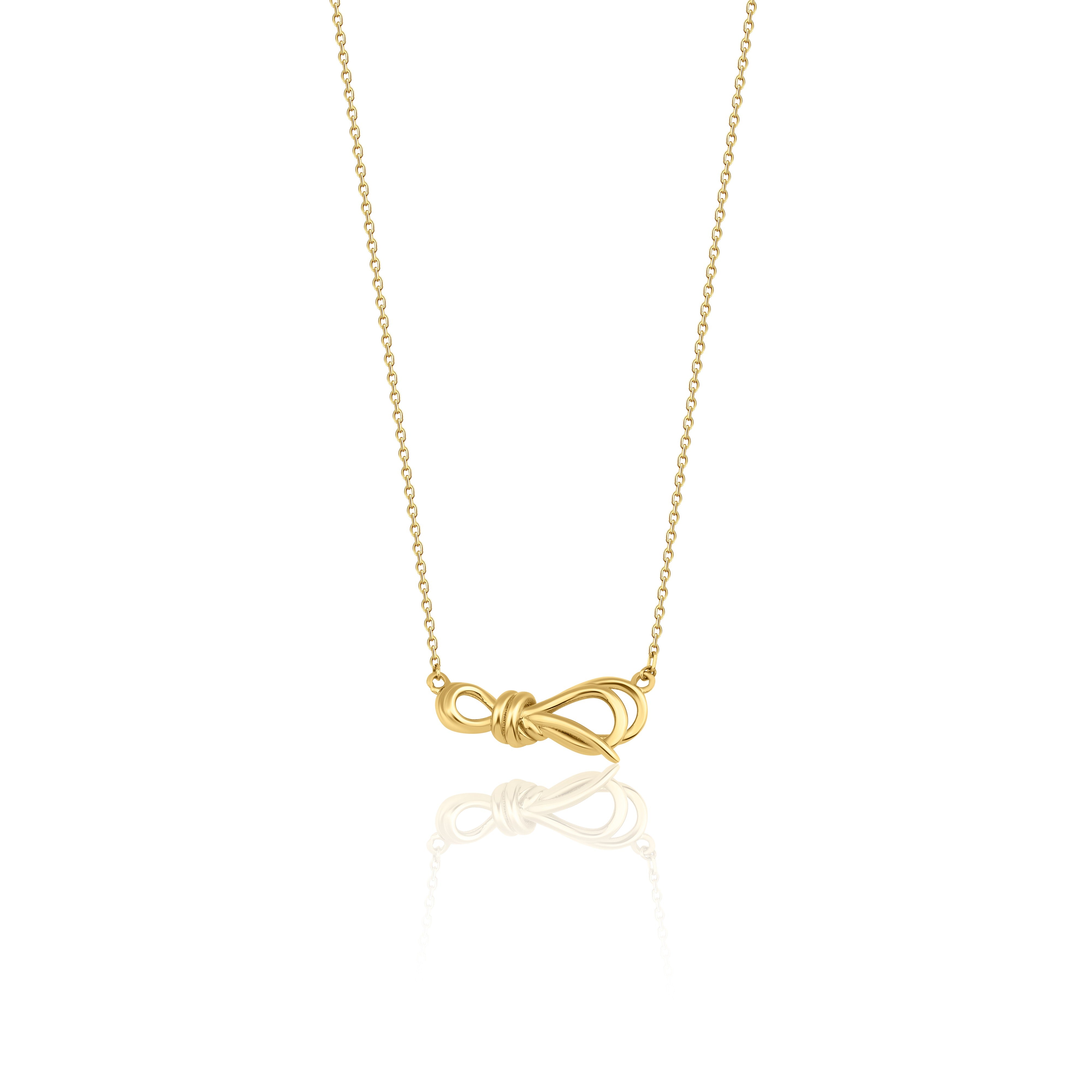 yellow gold ribbon knot necklace on white background