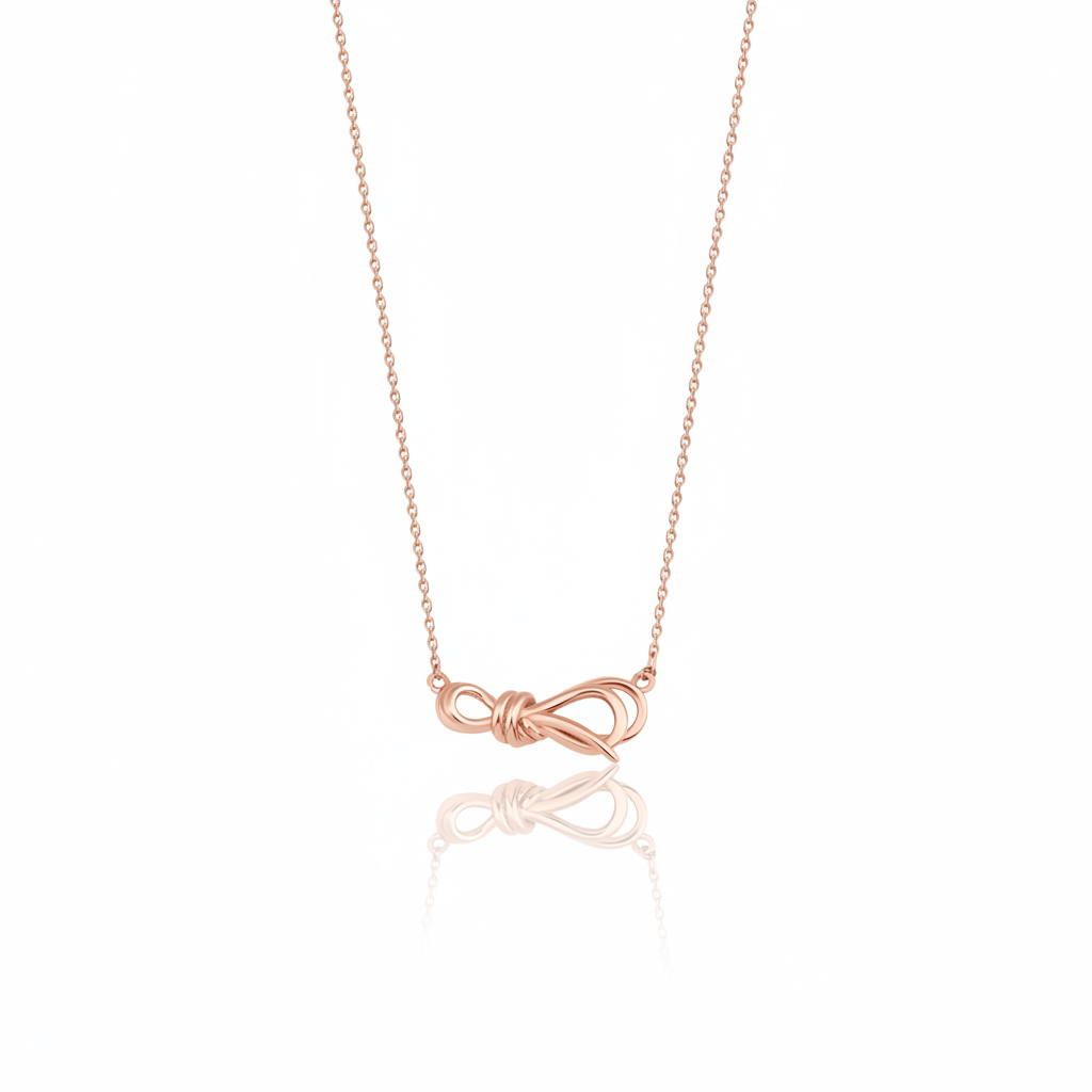 rose gold ribbon knot necklace on white background