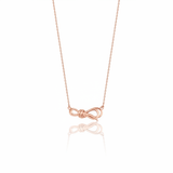 rose gold ribbon knot necklace on white background