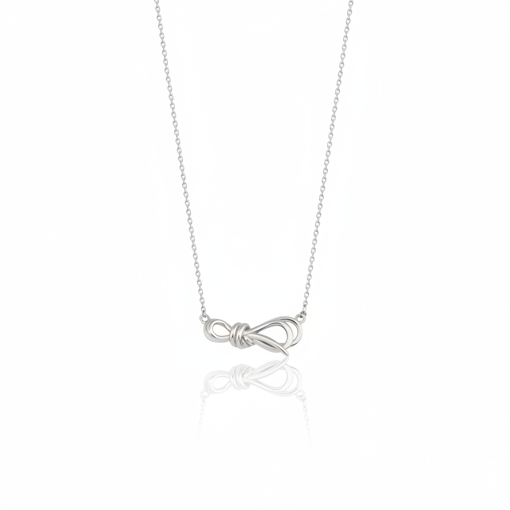 white gold ribbon knot necklace on white background