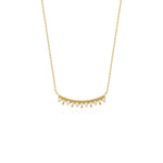yellow gold beaded arc necklace on white background