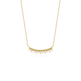 yellow gold beaded arc necklace on white background