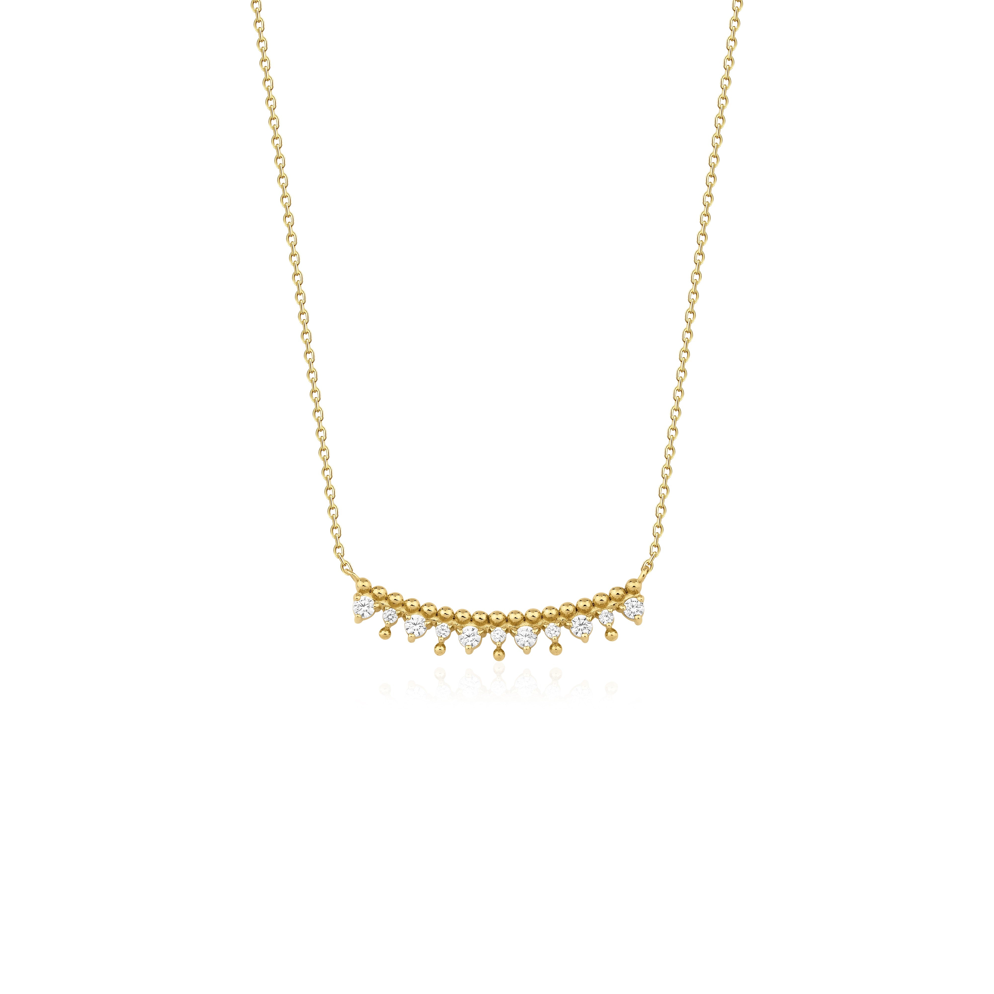yellow gold beaded arc necklace on white background