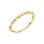 yellow gold heart band ring on white background