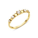 yellow gold graduated stone ring on white background