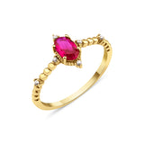 yellow gold ruby accent ring on white background