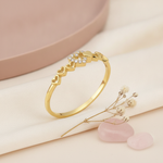 gold twin heart ring displayed on pink and cream satin with dried baby's breath and rose quartz stones