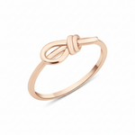 rose gold knot ring on white background