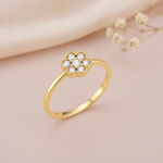gold floral cluster ring displayed on pink satin with dried baby's breath