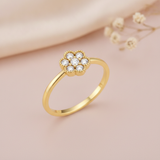 gold floral cluster ring displayed on pink satin with dried baby's breath